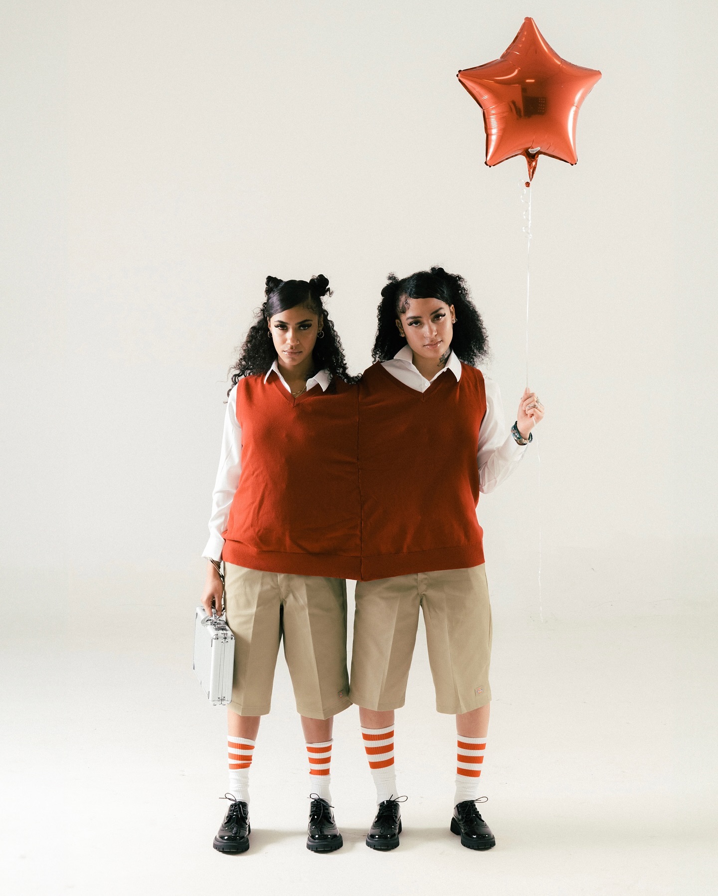 Lailah in a coordinated studio editorial with a red star balloon