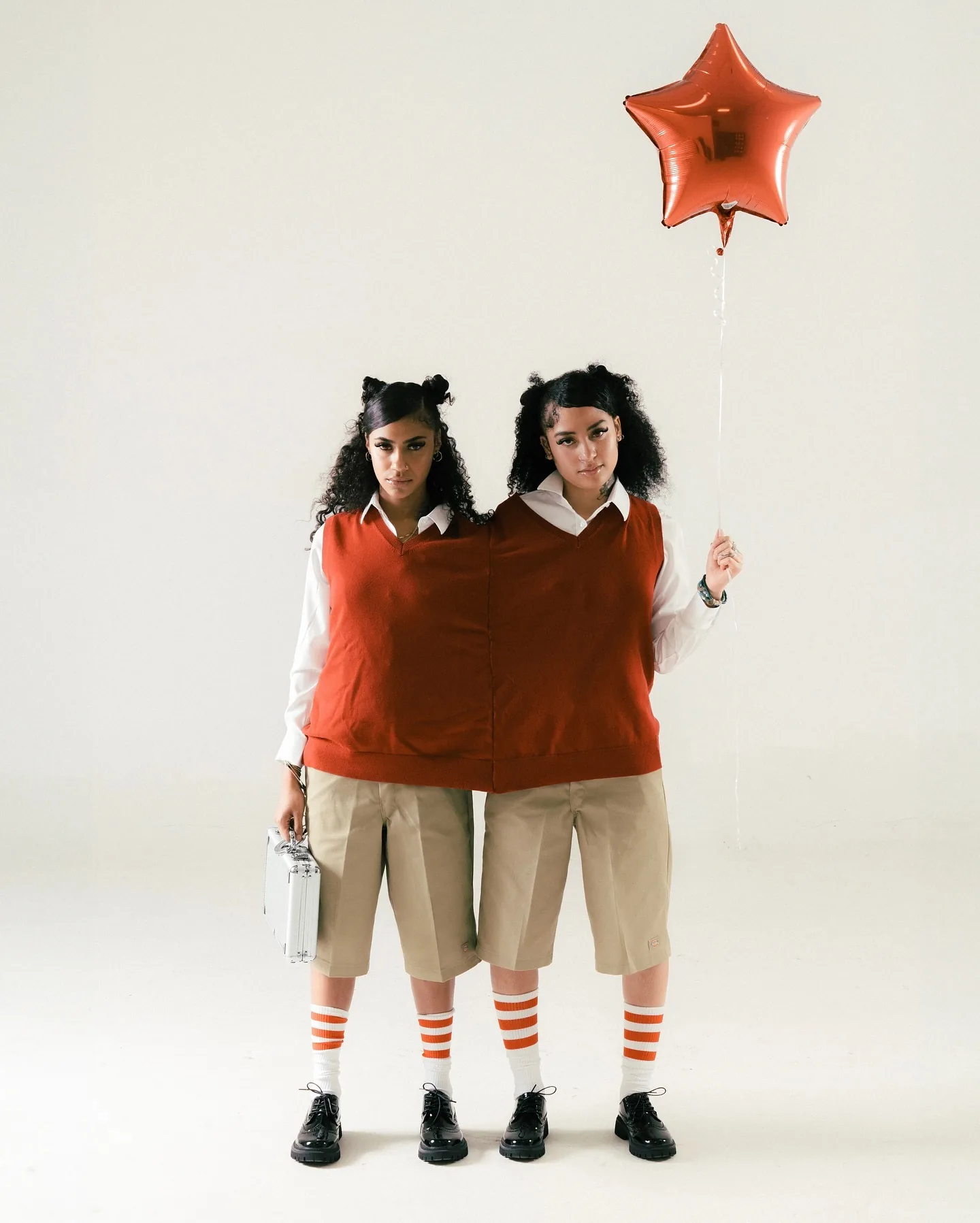 Lailah in a coordinated studio editorial with a red star balloon